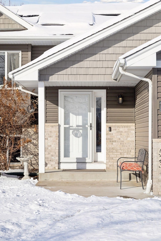 view of snow covered property entrance