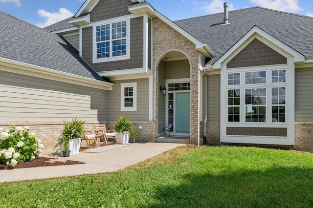 8051 165th St E, Credit River Twp, MN 55372 - view of front of home with brick siding, a front yard, and a shingled roof