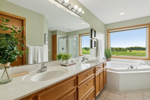 8051 165th St E, Credit River Twp, MN 55372 - bathroom featuring a stall shower, double vanity, tile patterned flooring, a bath, and recessed lighting