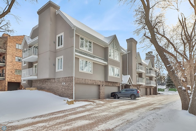 snow covered building with a garage