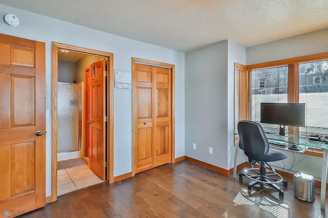 office area featuring dark hardwood / wood-style floors and a textured ceiling