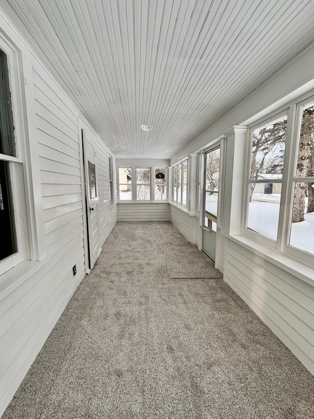 unfurnished sunroom featuring wooden ceiling