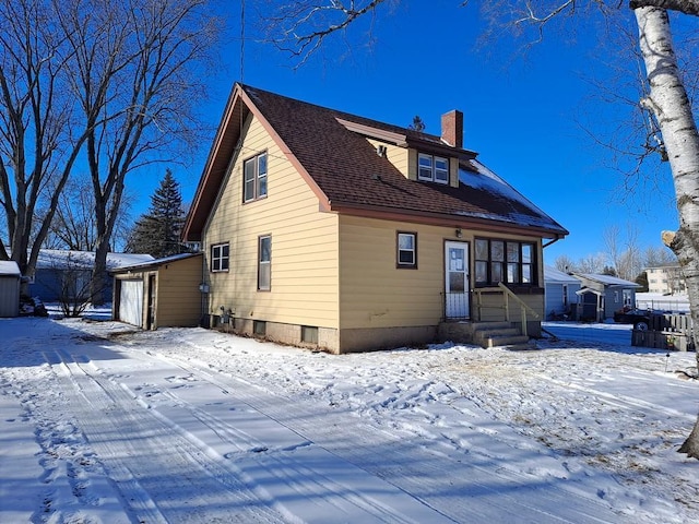 view of snow covered rear of property