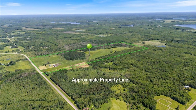 aerial view featuring a wooded view