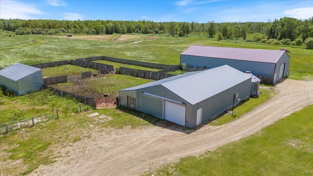 birds eye view of property featuring a forest view and a rural view