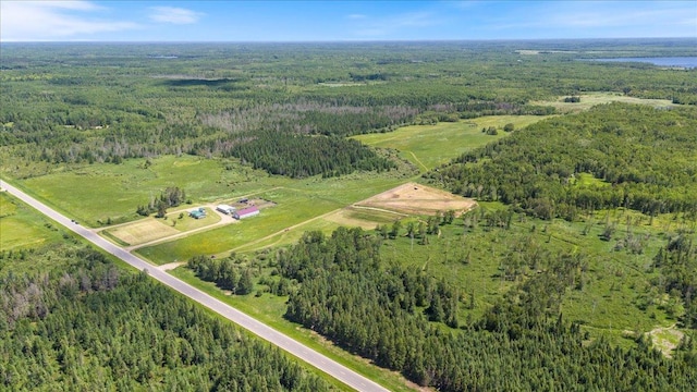 birds eye view of property with a view of trees