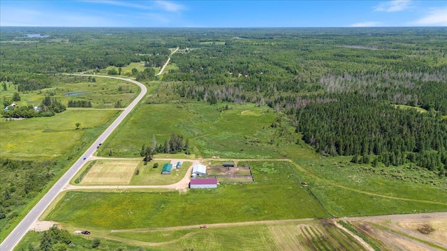 drone / aerial view with a view of trees and a rural view