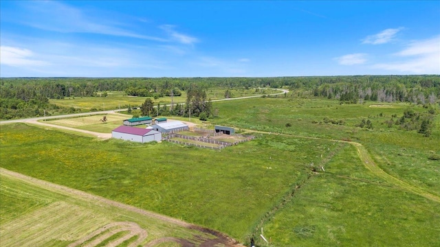 aerial view featuring a rural view and a wooded view