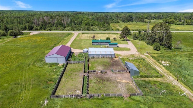 birds eye view of property featuring a rural view and a wooded view