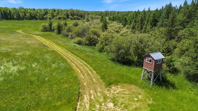 birds eye view of property featuring a view of trees