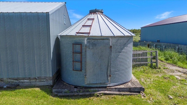 view of outbuilding featuring an outbuilding and fence