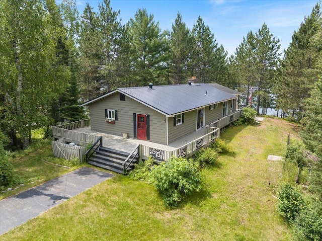 exterior space with a deck and a front lawn