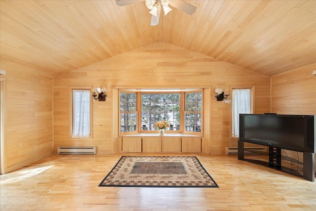 living room featuring plenty of natural light, baseboard heating, and wood walls