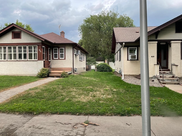 view of side of property with cooling unit and a lawn