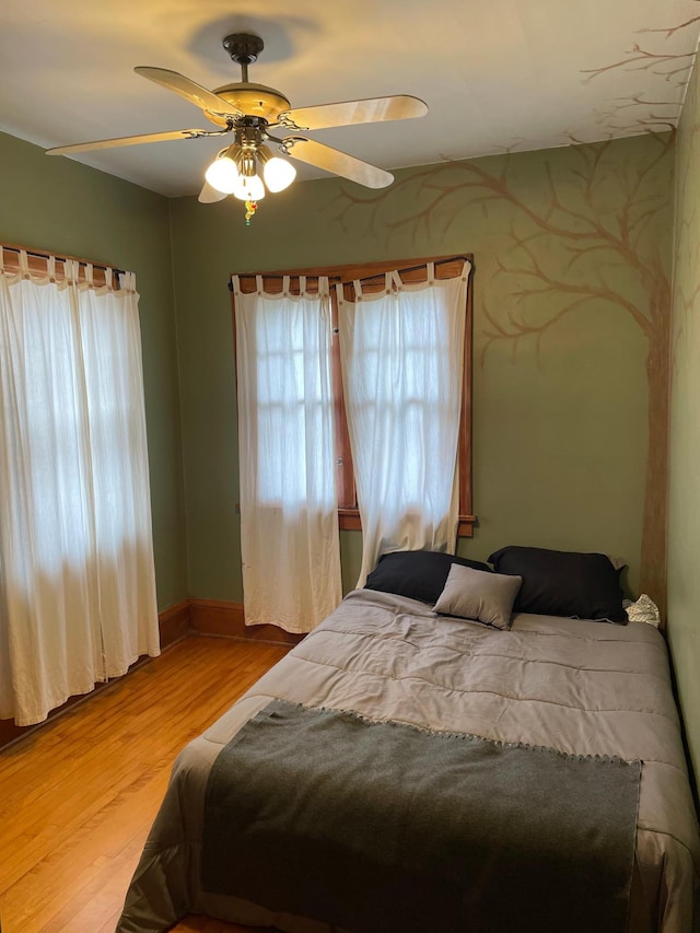 bedroom featuring light hardwood / wood-style floors and ceiling fan