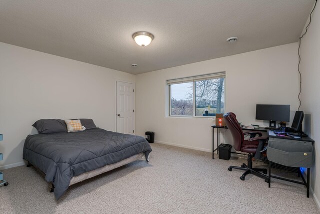 bedroom with carpet and a textured ceiling