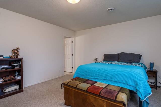 carpeted bedroom with a textured ceiling