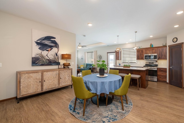 dining space with light wood-type flooring