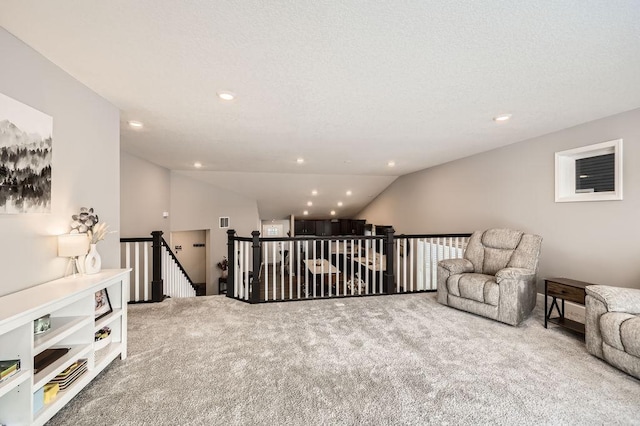 sitting room featuring lofted ceiling, carpet flooring, an upstairs landing, and recessed lighting