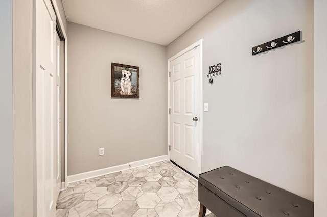 foyer featuring baseboards