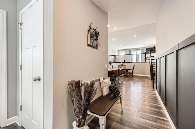 hall with recessed lighting, dark wood-style flooring, stairway, and baseboards