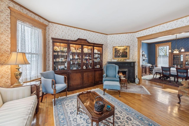 living room with wood-type flooring and ornamental molding
