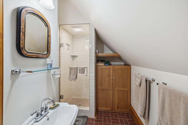 bathroom featuring vaulted ceiling and walk in shower