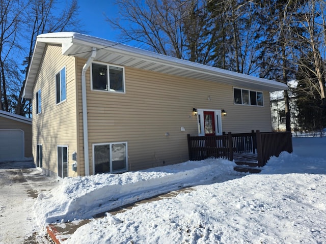 exterior space with an outbuilding and a detached garage