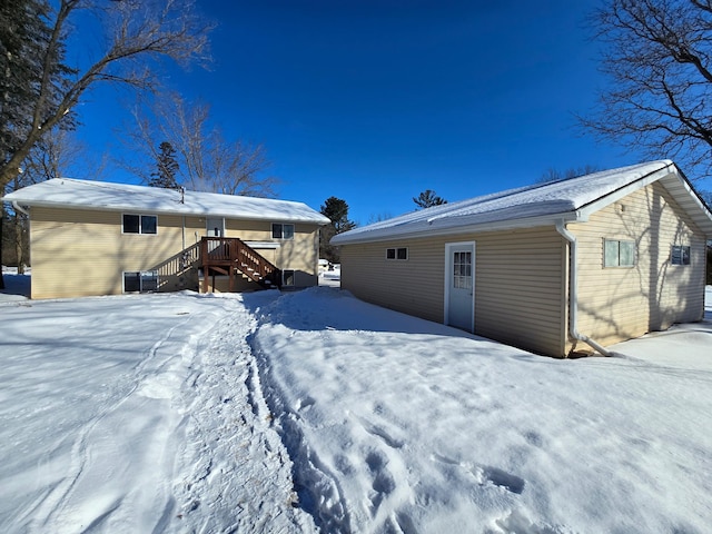 view of snow covered back of property