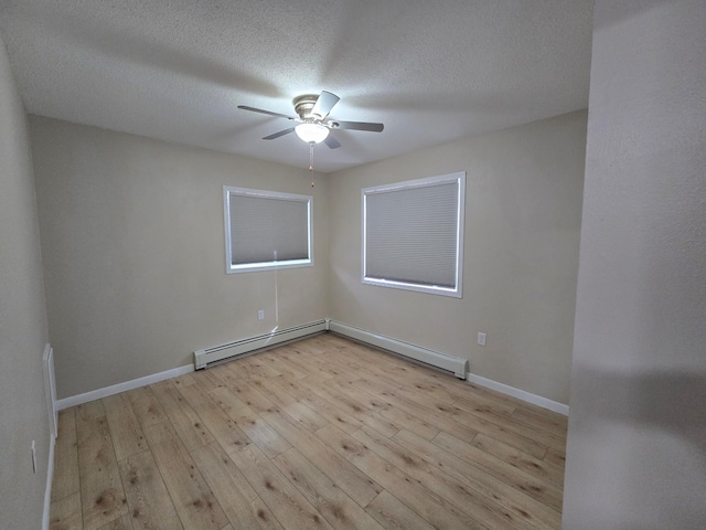 spare room featuring ceiling fan, a textured ceiling, baseboards, and light wood-style floors