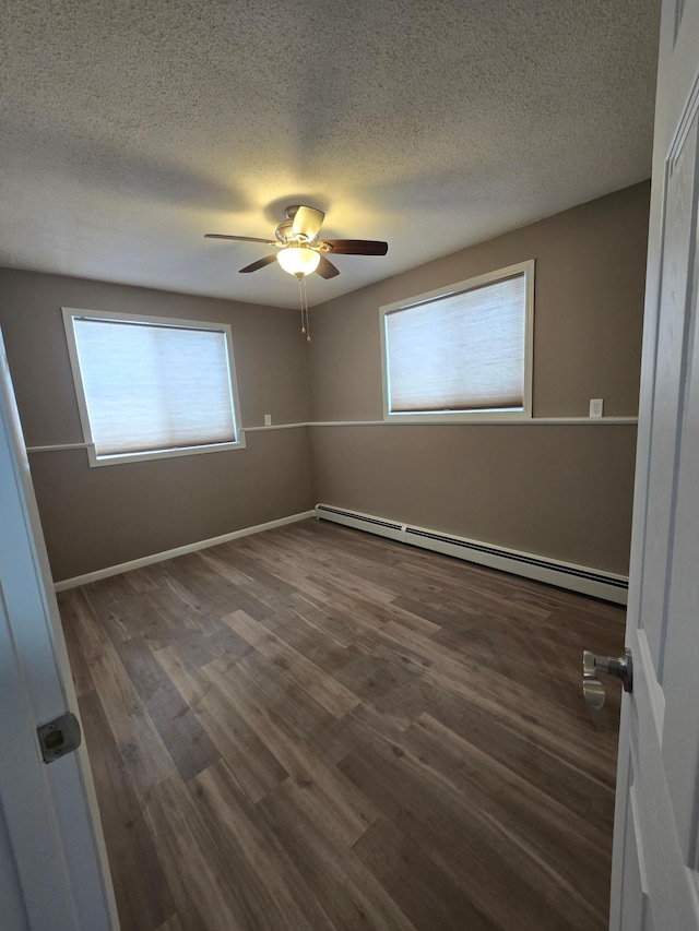 unfurnished bedroom featuring baseboards, a baseboard radiator, ceiling fan, wood finished floors, and a textured ceiling