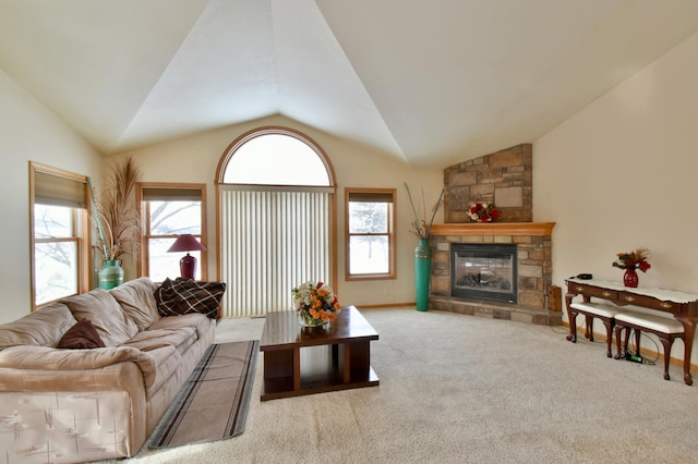 carpeted living room with a stone fireplace, plenty of natural light, and vaulted ceiling