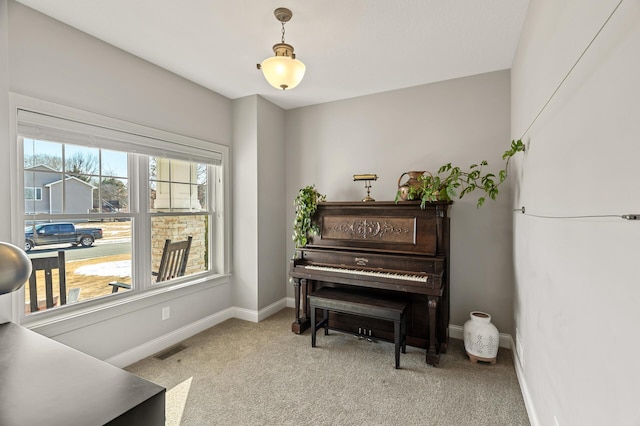 sitting room featuring visible vents, baseboards, and light colored carpet