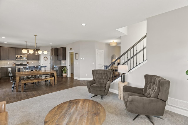 living room featuring visible vents, baseboards, dark carpet, stairs, and recessed lighting