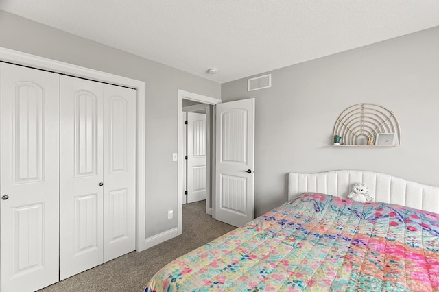 carpeted bedroom featuring a closet, visible vents, and baseboards