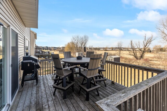 deck featuring a grill and outdoor dining space