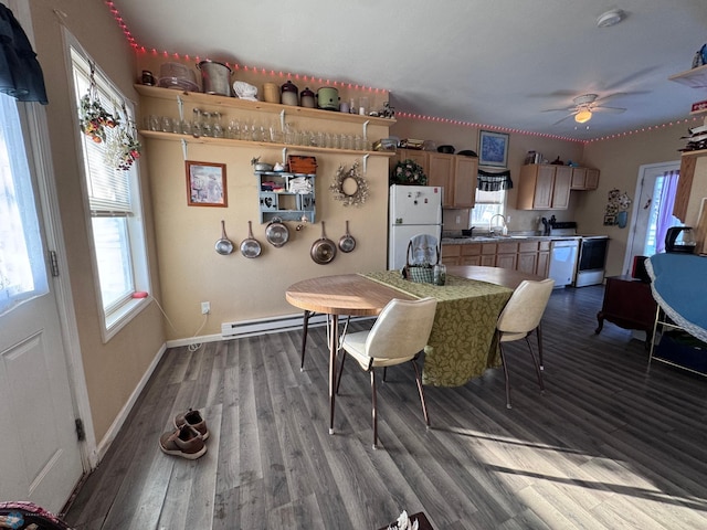 dining room with ceiling fan, a baseboard radiator, sink, and hardwood / wood-style floors