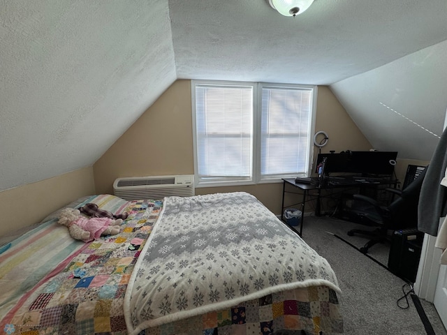 bedroom with lofted ceiling, carpet, a textured ceiling, and a wall unit AC