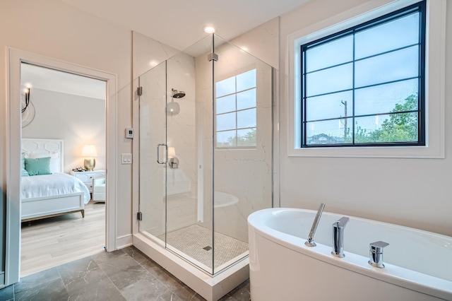 bathroom with a wealth of natural light and independent shower and bath