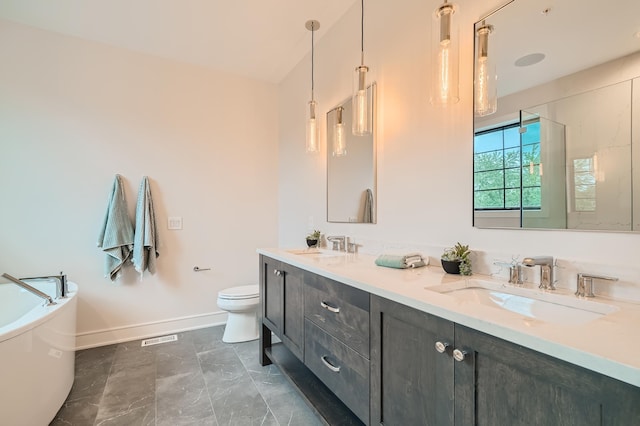 bathroom featuring vanity, toilet, and a bathing tub