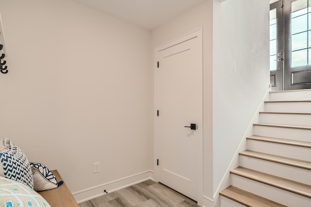 staircase with hardwood / wood-style flooring