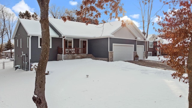 single story home featuring a garage and a porch