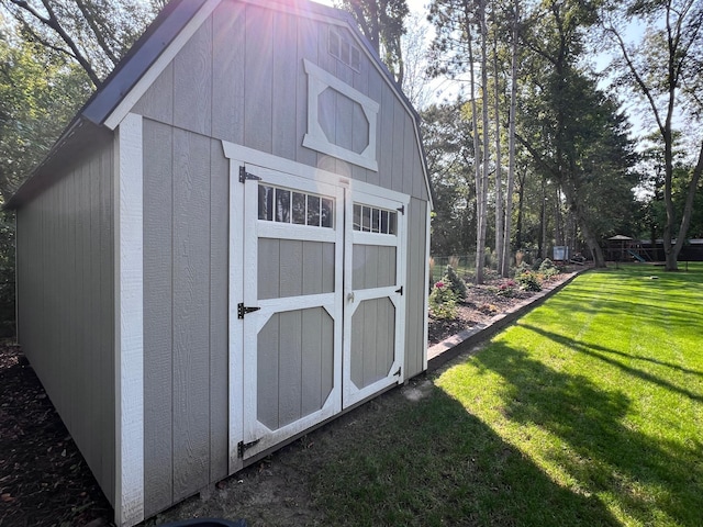 view of outdoor structure featuring a lawn