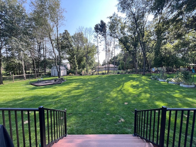 view of yard with a storage unit and a wooden deck