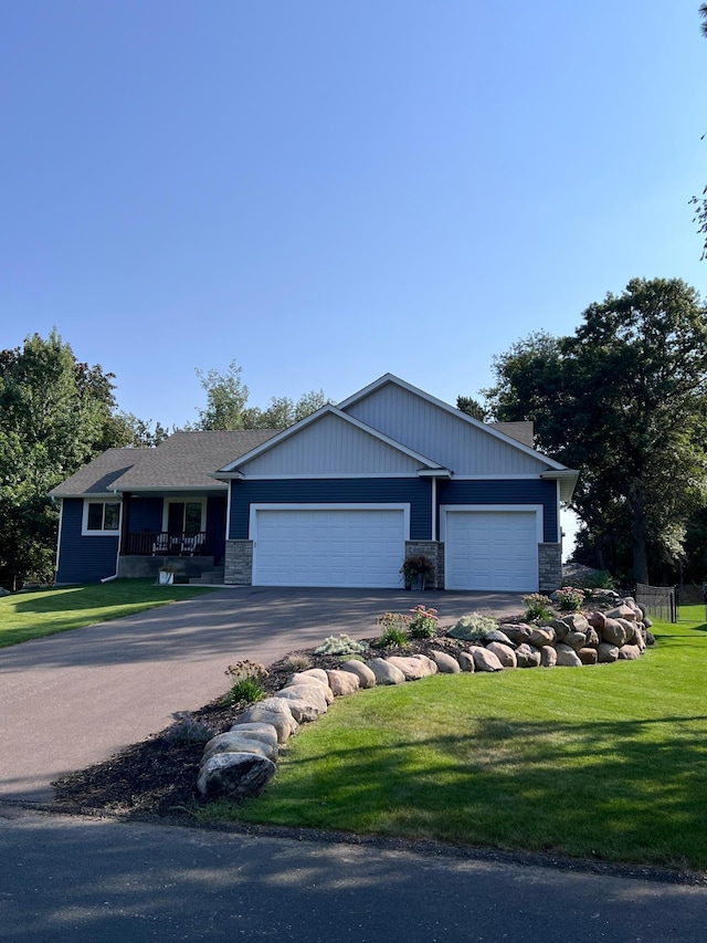 ranch-style house featuring a front yard and a garage