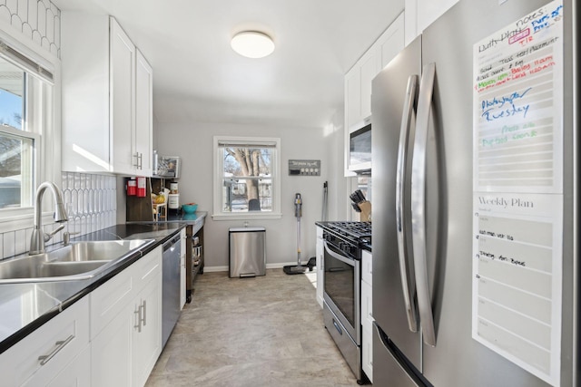 kitchen with white cabinetry, stainless steel appliances, and sink