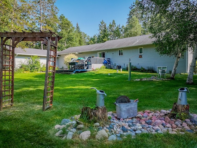 back of property with a lawn and a deck