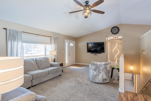 carpeted living room featuring vaulted ceiling, a ceiling fan, and baseboards