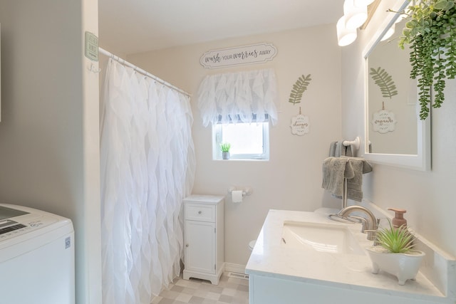 bathroom featuring washer / dryer and vanity