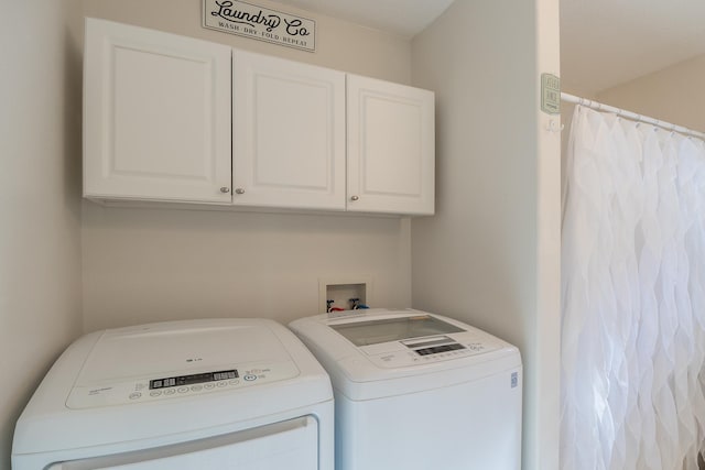 laundry room with cabinet space and washing machine and clothes dryer